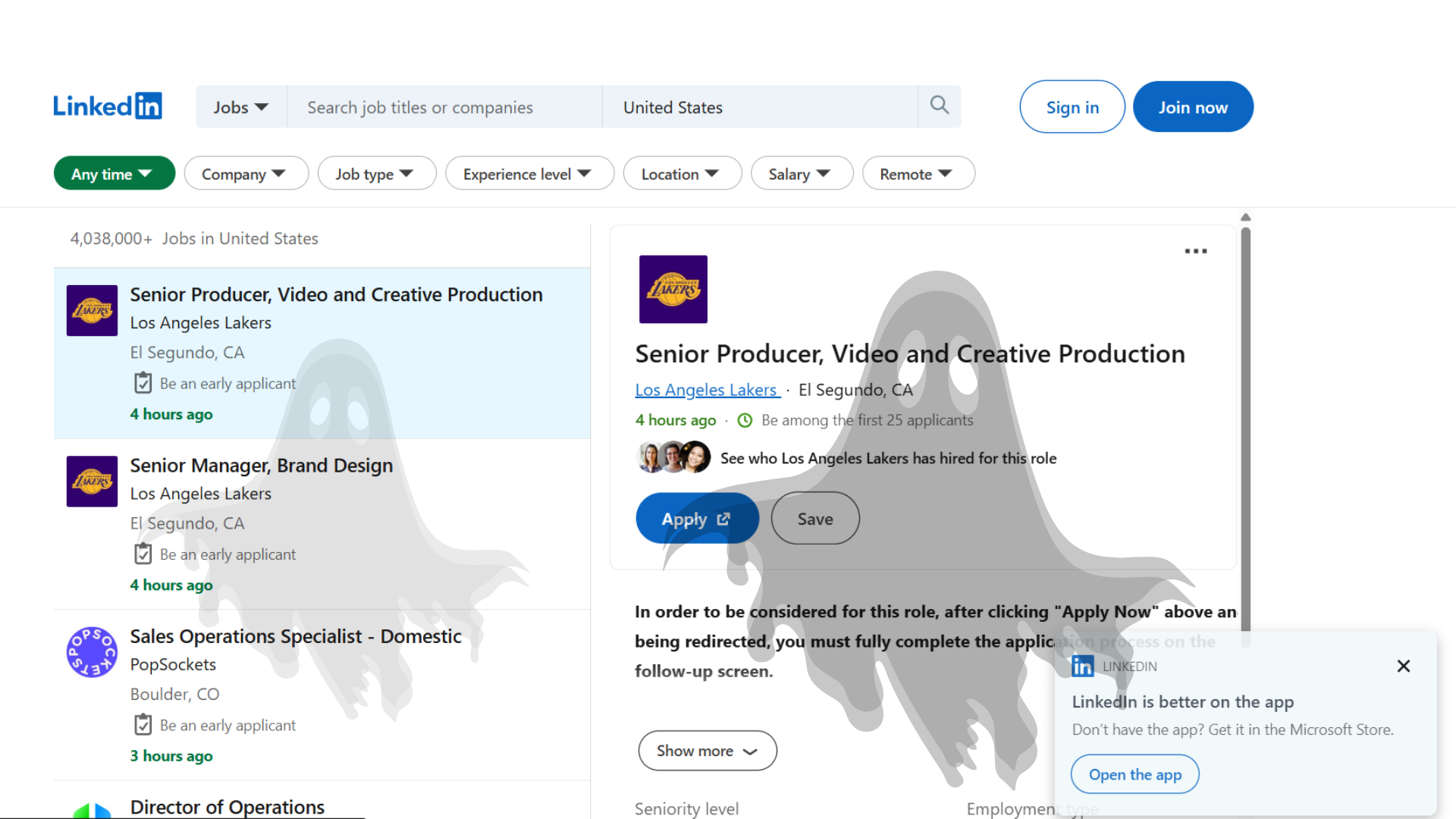 Illustration of a ghost floating over a job listing on a laptop screen, representing ghost jobs on aggregator platforms